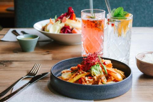 a bowl of food on a table with a plate of food at SchönBerg hotel b&b in Rio Bianco