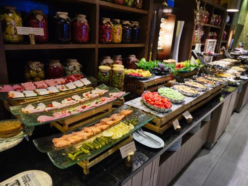a buffet with many different types of food on display at Qafqaz Tufandag Mountain Resort Hotel in Gabala