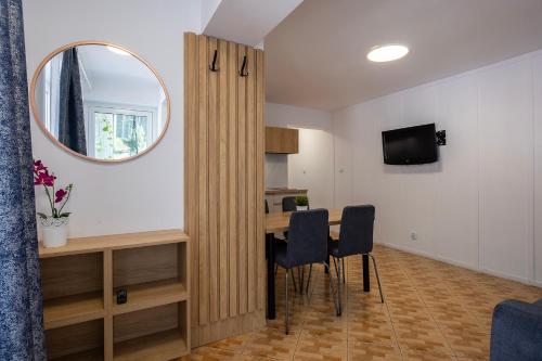 a room with a table and chairs and a mirror at 4 Pory Roku Apartamenty Domki Pokoje in Nadole