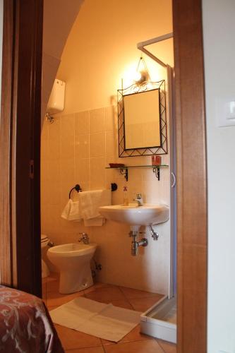a bathroom with a sink and a toilet and a mirror at Masseria La Guardata in Guglionesi