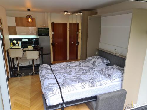 Cette chambre comprend un grand lit et une cuisine. dans l'établissement Studio à La Défense (climatisé, parking), à Courbevoie