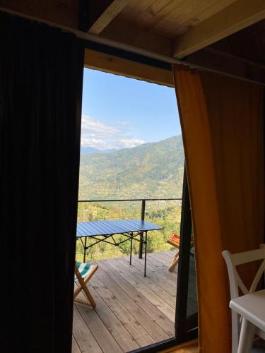 a view from the deck of a cabin with a view of the mountains at HillSide Cottage in Keda