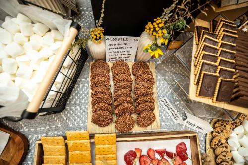 a table topped with different types of food and desserts at Under Canvas North Yellowstone - Paradise Valley in Livingston