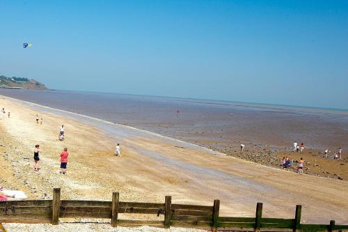 a group of people walking on a beach at Seaview in Leysdown-on-Sea