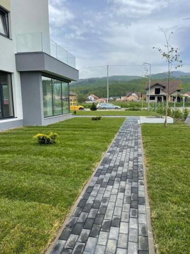 a brick path in front of a house at Deea H24 in Râşnov