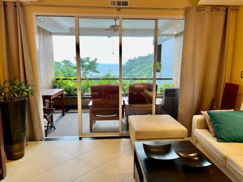 a living room with a couch and a view of the ocean at Luxury Apartment Kata Beach The Accenta in Kata Beach