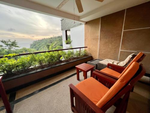 a balcony with furniture and a view of the ocean at Luxury Apartment Kata Beach The Accenta in Kata Beach