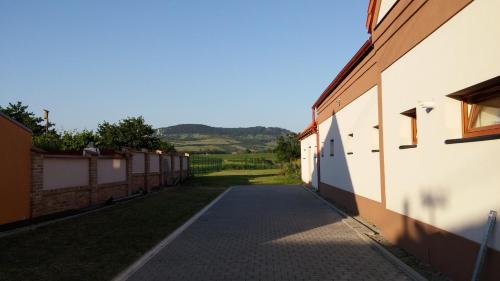 an alleyway between two buildings with a field in the background at Penzion Dolní Dunajovice in Dolní Dunajovice