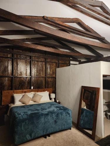 a bedroom with a bed and a mirror at Bosko cerro verde in Lomas de San Marcelino