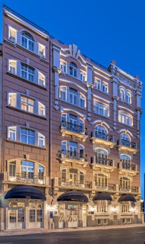 a large brown building with windows and balconies at H10 Duque de Loule in Lisbon