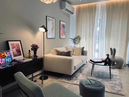 a living room with a couch and a table at Alice, 2-4 people, renovated stylish apartment in Athens