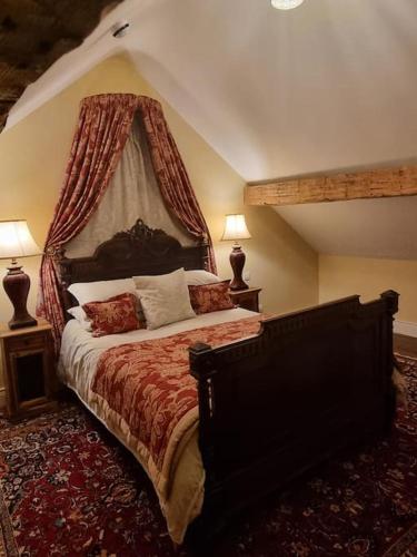 a bedroom with a large bed with a canopy at The Apartment Benone in Castlerock
