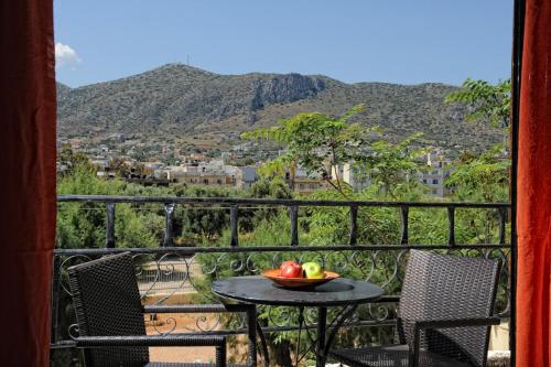 a table with a bowl of fruit on a balcony at Erofili Apartments in Hersonissos