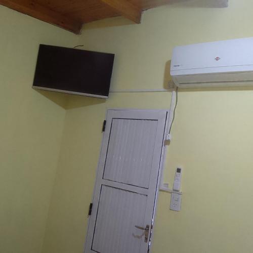 a door in the corner of a room with a air conditioner at Hospedaje jabuticaba in El Soberbio