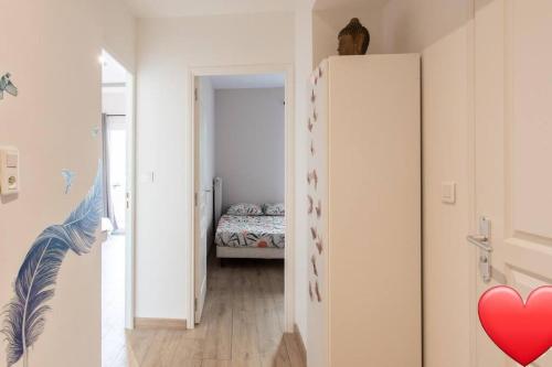 a room with a white refrigerator and a bedroom at Logement en plein coeur avec terrasse in Nice