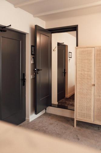 a room with two doors and a mirror at Hotel bij Jacob in Enschede