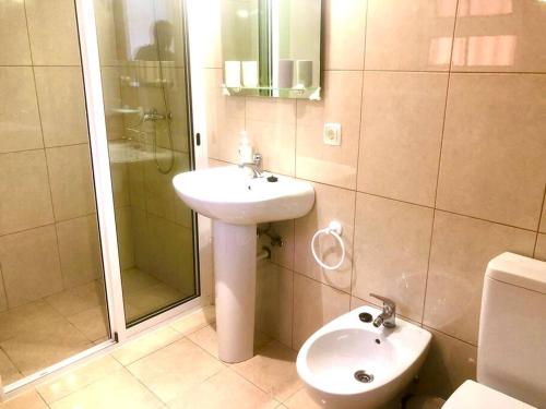 a bathroom with a sink and a shower and a toilet at Casa Vista Mar -2 bedrooms,fantastic Seaview in Estreito da Calheta