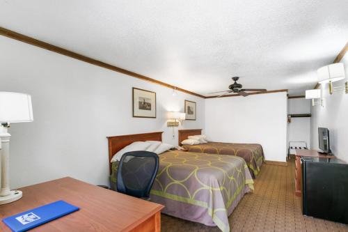 a hotel room with a bed and a table at Georgetown Lodge in Georgetown