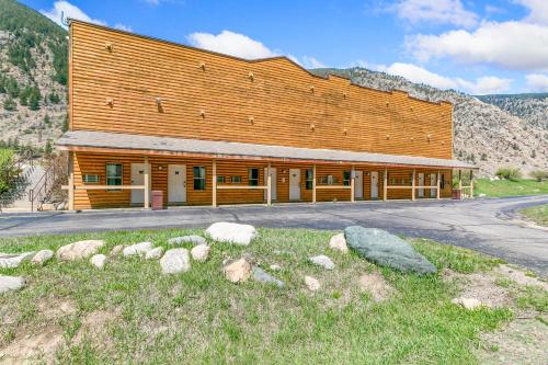 a large wooden building with rocks in front of it at Georgetown Lodge in Georgetown