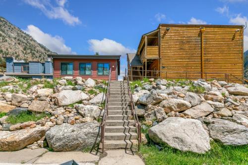 a house with a staircase leading to a pile of rocks at Georgetown Lodge in Georgetown