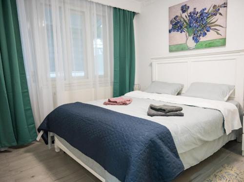 a bedroom with a bed with two towels on it at Escape Aparthotel in Suceava