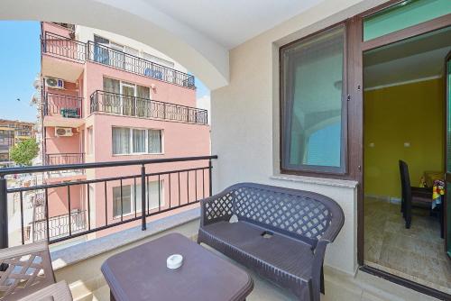 a balcony with a bench and a table at Evi Apartments 2 in Pomorie