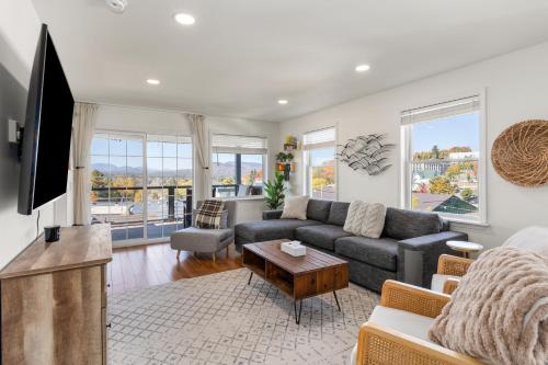 a living room with a couch and a tv at Amazing Mountain Views Lake Placid & 1980 Olympic Center in Lake Placid