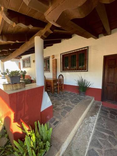 a patio of a house with a table and chairs at Cabaña Ledesma in Mazamitla