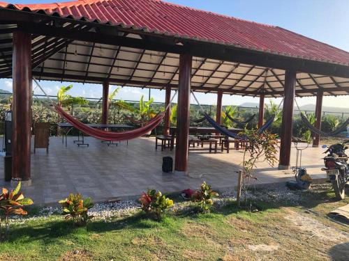 a pavilion with a hammock and picnic tables at Casa Bita Morales CASA 201 in Cartagena de Indias