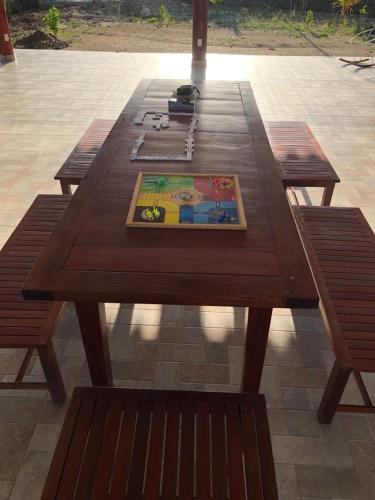 a wooden picnic table with two benches on a patio at Casa Bita Morales CASA 201 in Cartagena de Indias