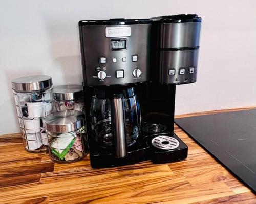 a coffee maker sitting on top of a wooden table at Romantic West End Apartment with Parking in Portland