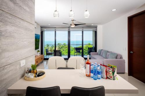 a living room with a table with drinks on it at Aloja oceanview in the Hotel Zone in Cancún
