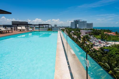 a swimming pool on the roof of a building at Aloja oceanview in the Hotel Zone in Cancún