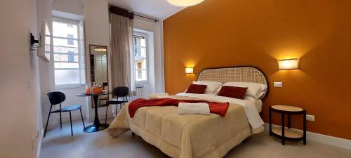 a bedroom with a bed and a table with chairs at Iaio River Suite in Rome