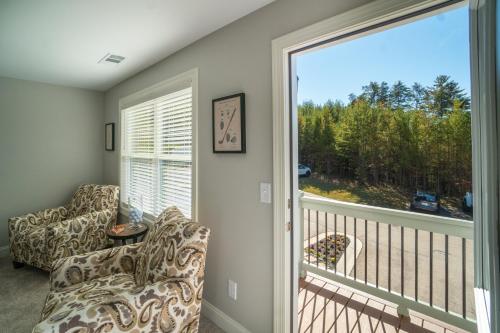a room with a balcony with a large window at Par-Tee Haus I- Game Room & Hot Tub-Walk to Helen in Helen