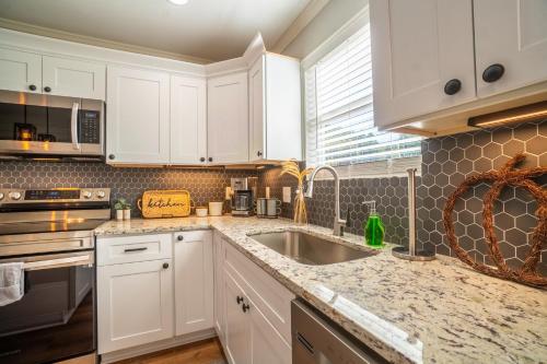 a kitchen with white cabinets and a sink at Par-Tee Haus I- Game Room & Hot Tub-Walk to Helen in Helen