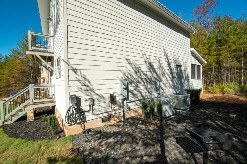 a backyard with a house with a grill and a patio at Par-Tee Haus I- Game Room & Hot Tub-Walk to Helen in Helen
