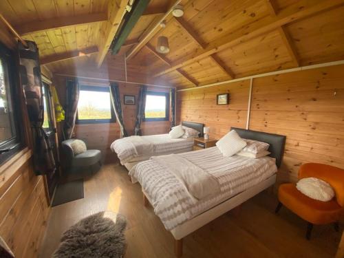 a bedroom with two beds in a log cabin at Carrowkeel Cabin in Sligo