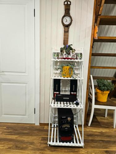 a white shelf with a microwave on it next to a door at B&B Cottage in Mestia in Mestia