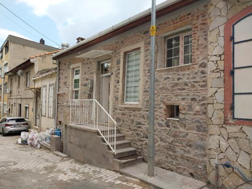 a brick building with stairs on the side of it at Beautiful stone guesthouse in cool Konak district in Konak