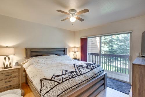 a bedroom with a bed with a ceiling fan and a balcony at Cozy Colorado Retreat with Deck, Grill and Pool Access in Edwards