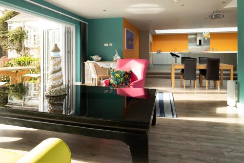 a living room with a table and a dining room at Talland Bay Hotel, Looe in Talland