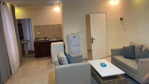 a living room with a couch and a table at 1 bedroom first in Amman