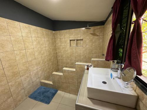 a bathroom with a sink and a shower at El mangal B&B in Suchitoto