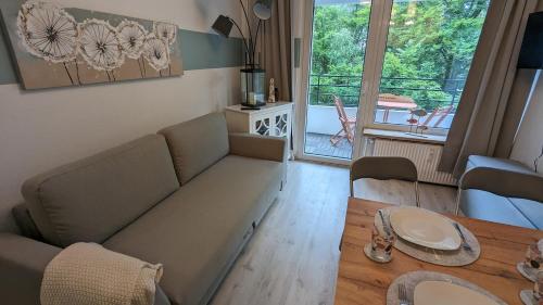 a living room with a couch and a table at Wald und Meer in Glücksburg