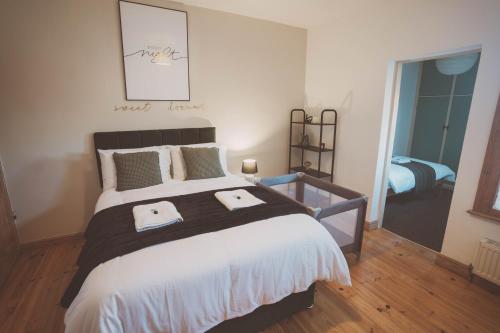 a bedroom with a large bed with two towels on it at Well Equipped 5 beds 2 bathrooms town House in Coventry City near Amenties CONTRACTOR DIGS 5 Beds in Coventry