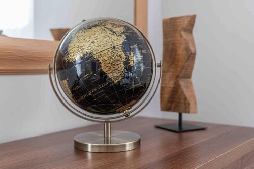 a globe on top of a wooden table at Spacious Apartment, Near Birmingham Centre + NEC in Birmingham