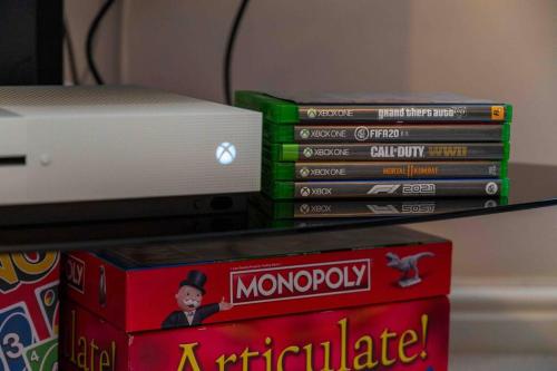 a stack of dvds sitting on a shelf at Spacious Apartment, Near Birmingham Centre + NEC in Birmingham