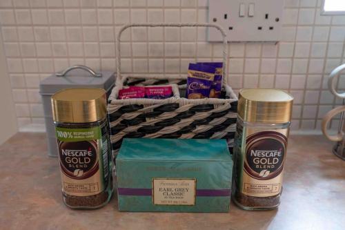 a counter with two bottles of spices and a box of nuts at Spacious Apartment, Near Birmingham Centre + NEC in Birmingham