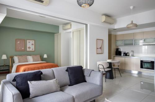 a living room with a couch and a bed at Beautiful Studio apartment in Singapore! in Singapore